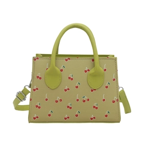 Fashionable green cherry print crossbody bag with dual handles and adjustable strap