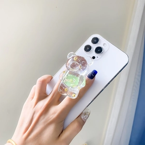 Detailed macro view of a 3D transparent resin bear phone grip with gold foil flakes