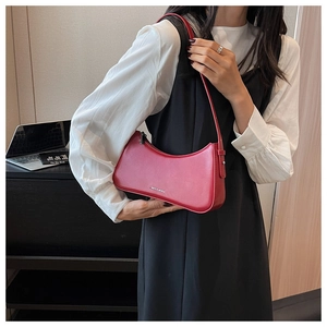 Chic red crescent-shaped leather shoulder bag with sleek metallic zipper detail