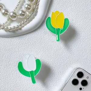 Detail of tulip phone grip stand set in yellow and white acrylic on textured background