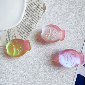 Close-up of translucent laser-effect fish-shaped phone grips in colorful gradients