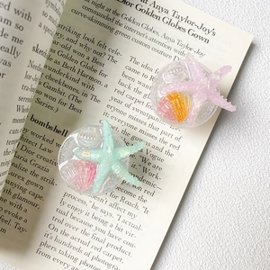 Detail of resin phone sockets with glitter and nautical starfish and shell elements