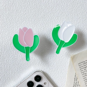 Detailed view of glossy tulip-shaped phone socket holders in pink and white