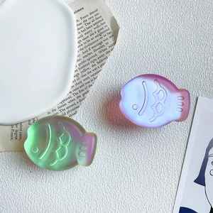 Close-up of translucent matte fish-shaped expandable phone sockets in gradient colors