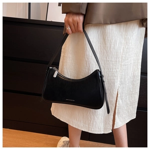 Detail of a black faux leather rectangular baguette bag with JINFEI & MEIPAI branding