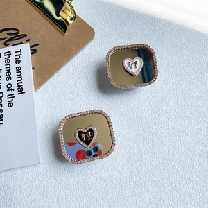 Detail of luxury rhinestone heart phone socket with mirror finish and golden bow