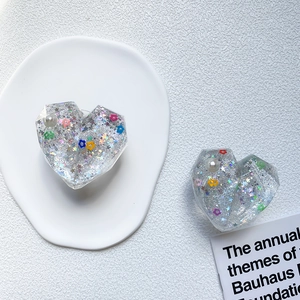 Glittering heart phone grip with colorful sequins and pearls in clear resin finish