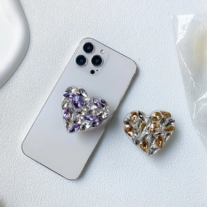 Detail of luxury rhinestone heart-shaped phone grip showing sparkling crystal facets
