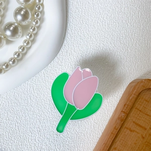 Detailed view of tulip flower phone grip with pink petals and green leaves on white surface