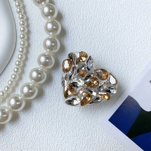 Detailed close-up of luxury heart phone grip with sparkling champagne rhinestones