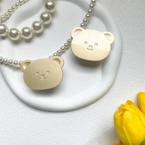 Detail shot of cute matte gold bear phone stand accessories in a stylish setting