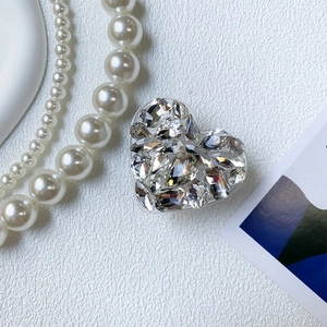 Close-up of heart-shaped luxury rhinestone phone grip with sparkling multi-cut crystals