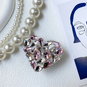 Detailed view of luxury heart phone grip with pink rhinestones and crystals