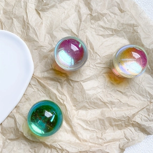 Macro shot of telescopic phone stand crystal balls with glitter texture on textured paper