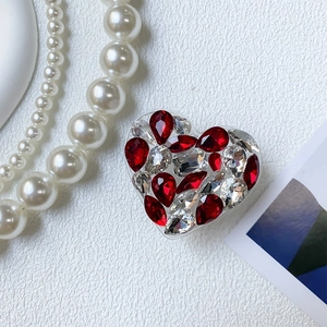 Macro shot of luxury heart shaped phone grip encrusted with red and white rhinestones