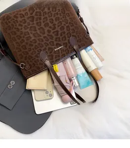 Top view of large leopard print tote bag interior showing spacious storage for laptop and items