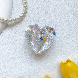 Sparkly heart phone grip with colorful flowers and silver glitter on white background