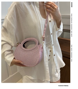 Détail du sac à main rose en strass avec poignée circulaire et fermeture éclair en métal