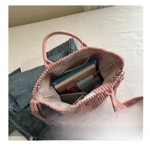 Pink corduroy tote bag showing large capacity with laptop and daily essentials inside