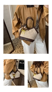 Detail of quilted bucket bag featuring a V-shaped opening and gold JDH logo accent
