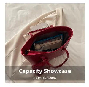 Spacious red leather tote bag showing capacity for tablet, notebook, and accessories
