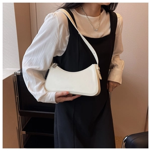 Minimalist white vegan leather hobo bag styled with a 90s vintage chic aesthetic