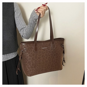 Close-up of leopard print large tote bag with Creative Cat text and side drawstring detail