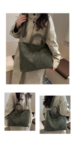 Detailed close-up showing the green corduroy texture and TOTE BAG embroidery on the bag