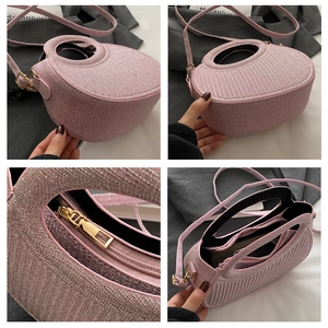 Detail of pink woven handbag featuring metal zipper and multi-layer internal compartments