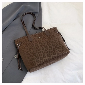 Detail of leopard print tote bag with Creative Cat text and side tassel drawstrings