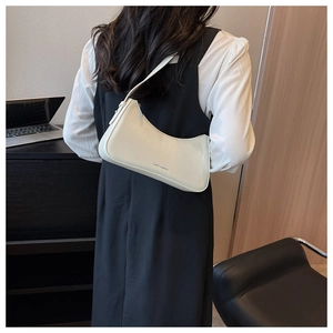 Chic cream white hobo bag shown in a professional office setting with elegant leather finish