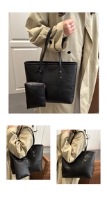 Detail of black pebbled leather tote bag set including a large purse and small pouch