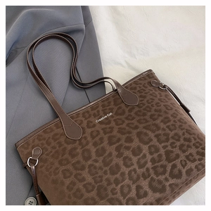 Detail of leopard print tote bag showing matte texture and Creative Cat text branding