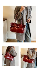 Detail of burgundy patent leather tote with adjustable buckle strap and long handles