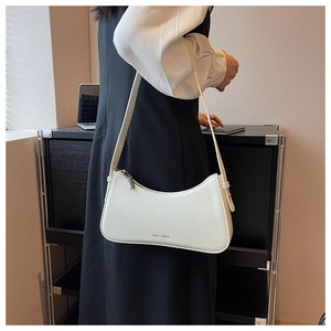 Chic white leather crescent shoulder bag with silver zipper and adjustable strap