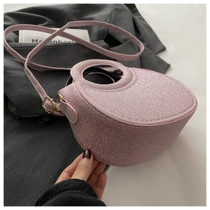 Pink embossed crescent handbag with circular handle and gold metal details