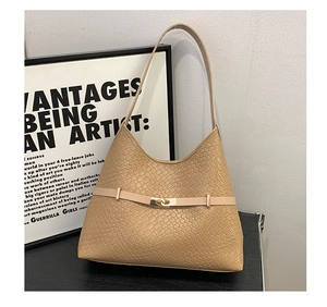 Close-up of beige woven texture shoulder bag with golden buckle and belt detail