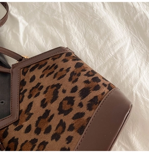 Close-up of leopard print fabric detail and high-quality stitching on the tote handbag