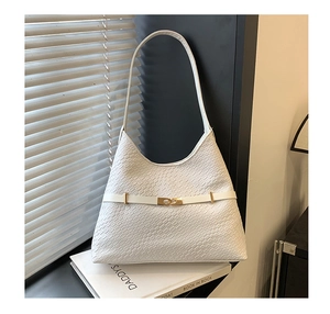 Detail of white woven leather shoulder bag featuring a sleek golden metal buckle accent