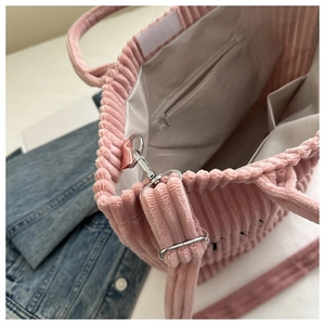 Detail view of pink corduroy tote bag showing interior lining and zippered pocket