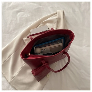 Top view of large red tote bag interior showing spacious capacity for tablets and essentials