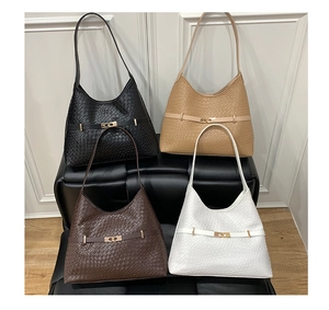 Detail of woven texture hobo bags in black, khaki, brown, and white with gold hardware