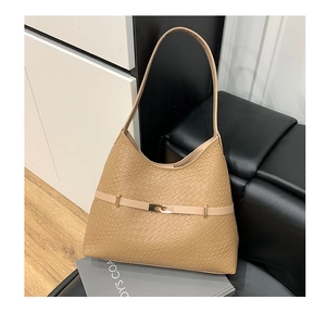 Detail of camel woven texture shoulder bag with gold metal buckle and leather strap
