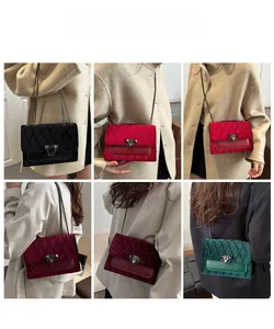 Detail view of velvet crossbody bags with diamond quilting and metallic chain straps