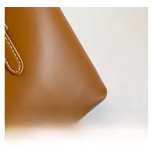 Detailed macro view of soft brown leather texture with high-quality white stitching
