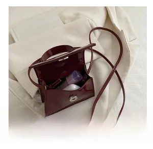 Detail showing the inner capacity of this glossy dark wine red patent leather handbag