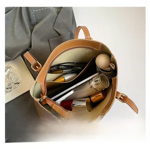 Internal storage detail of caramel leather tote bag showing spacious compartments