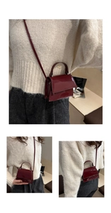 Detailed macro view of burgundy patent leather mini crossbody bag with glossy mirror finish