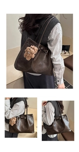Detail of dark brown tote bag featuring a leather texture and a cute plush bear pendant