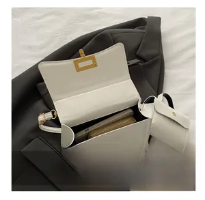 Detail showing white leather crossbody bag interior capacity for phone and wallet